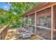 Inviting screened porch area featuring outdoor seating, a cozy fire pit, and views of the surrounding landscape at 805 Mcarthur Ave, Sarasota, FL 34243
