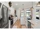 Well-lit kitchen with stainless steel appliances, modern fixtures, island, and ample cabinet space at 8273 Givlic Ln, North Port, FL 34287