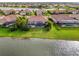 An aerial view of a backyard with a screened-in pool that faces the lake, perfect for entertaining or relaxing at 8290 Barton Farms Blvd, Sarasota, FL 34240