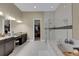 A bathroom with a soaking tub, glass enclosed shower and double vanity sinks at 8901 Artisan Way, Sarasota, FL 34240