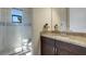 Bright bathroom featuring a walk-in shower and a sink with marble countertops at 8901 Artisan Way, Sarasota, FL 34240