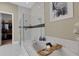 Bathroom featuring a glass shower, soaking tub, and tile accents with view of walk-in closet at 8901 Artisan Way, Sarasota, FL 34240