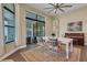 Bright dining room with table, wood floors, and access to an outdoor patio at 8901 Artisan Way, Sarasota, FL 34240