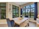 Bright dining room with large windows offering scenic views and stylish furnishings at 8901 Artisan Way, Sarasota, FL 34240