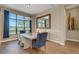 Formal dining room with scenic views, natural light, and a decorative mirror at 8901 Artisan Way, Sarasota, FL 34240