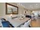 Open dining area with great lighting and views of the modern kitchen design at 8901 Artisan Way, Sarasota, FL 34240