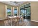 Bright dining room featuring large windows, wood floors, and access to an outdoor patio at 8901 Artisan Way, Sarasota, FL 34240