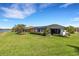 Beautiful home exterior with lush green lawn and water view at 8901 Artisan Way, Sarasota, FL 34240