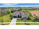 Stunning home with lush landscaping, tile roof, and serene surroundings by the lake at 8901 Artisan Way, Sarasota, FL 34240