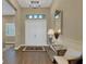Welcoming foyer with a double door entry, wood floors, and a decorative mirror at 8901 Artisan Way, Sarasota, FL 34240