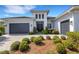 Lovely front exterior with a two car garage and beautiful landscaping at 8901 Artisan Way, Sarasota, FL 34240
