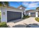 Home featuring a two car garage and manicured landscaping at 8901 Artisan Way, Sarasota, FL 34240