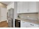 Modern kitchen features stainless steel appliances, white cabinets, and granite countertops at 8901 Artisan Way, Sarasota, FL 34240