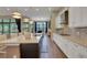 Modern open concept kitchen with an island, bar seating, and stainless steel appliances at 8901 Artisan Way, Sarasota, FL 34240