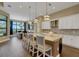 Bright, modern kitchen featuring a large island, bar stools, and stainless steel appliances at 8901 Artisan Way, Sarasota, FL 34240