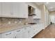 Elegant kitchen with granite countertops, white cabinets, and stainless steel appliances at 8901 Artisan Way, Sarasota, FL 34240