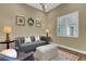 Comfortable living room with a gray sofa, a leather chair, and an area rug at 8901 Artisan Way, Sarasota, FL 34240