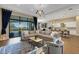 Bright, open living space with a modern sectional sofa, stylish decor, and access to the lanai at 8901 Artisan Way, Sarasota, FL 34240