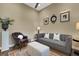 Comfortable living room with gray sofa, leather chair, and rug at 8901 Artisan Way, Sarasota, FL 34240