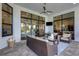 Spacious outdoor patio featuring comfortable seating, stone pavers, and view of the yard at 8901 Artisan Way, Sarasota, FL 34240