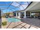 Inviting screened-in pool with lounge chairs and views of lush landscaping at 8901 Artisan Way, Sarasota, FL 34240