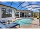 Beautiful screened-in pool with lounge chairs, pavers, and expansive outdoor living spaces at 8901 Artisan Way, Sarasota, FL 34240