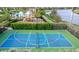 An aerial view of the meticulously maintained community tennis court and playground at 8901 Artisan Way, Sarasota, FL 34240