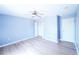 Bedroom features light blue walls, white trim, wood floors, and white closet doors at 924 Euclid Rd, Venice, FL 34293