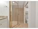 Shower features gold enclosure and floor-to-ceiling tiling at 9415 Discovery Ter # 101A, Bradenton, FL 34212