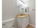 Clean, simple bathroom includes a large mirror and tiled flooring at 9415 Discovery Ter # 101A, Bradenton, FL 34212