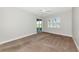 Carpeted bedroom showcasing a ceiling fan, sliding glass door, and window with shutter blinds at 9415 Discovery Ter # 101A, Bradenton, FL 34212