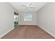 Carpeted bedroom featuring a ceiling fan, sliding glass door, and window with shutter blinds at 9415 Discovery Ter # 101A, Bradenton, FL 34212