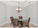 Cozy dining area with chandelier lighting and an outdoor view at 9415 Discovery Ter # 101A, Bradenton, FL 34212