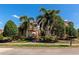 Beautiful Mediterranean-style home with lush landscaping, mature palm trees and brick walkway at 9415 Discovery Ter # 101A, Bradenton, FL 34212