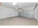 Spacious two car garage with a white walls, bare cement floor, and metal garage door at 9415 Discovery Ter # 101A, Bradenton, FL 34212