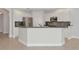 Bright kitchen features white cabinets, gray backsplash, and stainless-steel appliances at 9415 Discovery Ter # 101A, Bradenton, FL 34212