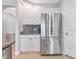 The kitchen features white cabinets, stainless steel refrigerator and granite countertops at 9415 Discovery Ter # 101A, Bradenton, FL 34212
