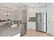 The kitchen features granite countertops, stainless steel appliances, white cabinets and neutral tile flooring at 9415 Discovery Ter # 101A, Bradenton, FL 34212