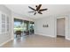 Bright living room features tile flooring, fan, and screened patio access at 9415 Discovery Ter # 101A, Bradenton, FL 34212