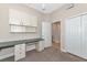 Office with built-in desk and cabinets featuring carpeted floor at 9415 Discovery Ter # 101A, Bradenton, FL 34212