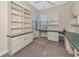 Office area featuring custom built-ins, desk, and natural light from two windows at 9415 Discovery Ter # 101A, Bradenton, FL 34212