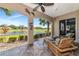 Serene screened patio with seating and views of the pond and landscaped garden at 9415 Discovery Ter # 101A, Bradenton, FL 34212
