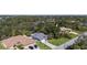 Scenic aerial view of a residential neighborhood with lush greenery and spacious yards at 106 Kings Dr, Rotonda West, FL 33947