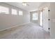 Inviting bedroom with three windows, a ceiling fan, and a sliding glass door at 1113 Cane Mill Ln, Bradenton, FL 34212