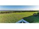 A lush green lawn extends towards the water, creating a serene and picturesque backyard setting at 1153 Edgewater Cir, Bradenton, FL 34209