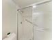 Bathroom with tiled shower, glass door, and handrail at 1153 Edgewater Cir, Bradenton, FL 34209