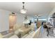 Light dining area includes a glass-top table with seating, leading to the living room and a beautiful view at 1153 Edgewater Cir, Bradenton, FL 34209