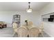 Bright dining area features a glass-top table and seating for four at 1153 Edgewater Cir, Bradenton, FL 34209