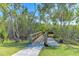 Scenic dock and boardwalk surrounded by trees at 1153 Edgewater Cir, Bradenton, FL 34209
