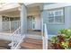 Inviting condo entrance with decorative plants, exterior lighting, and a well-maintained walkway at 1153 Edgewater Cir, Bradenton, FL 34209